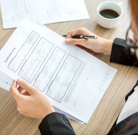 young-businesswoman-reading-application-form